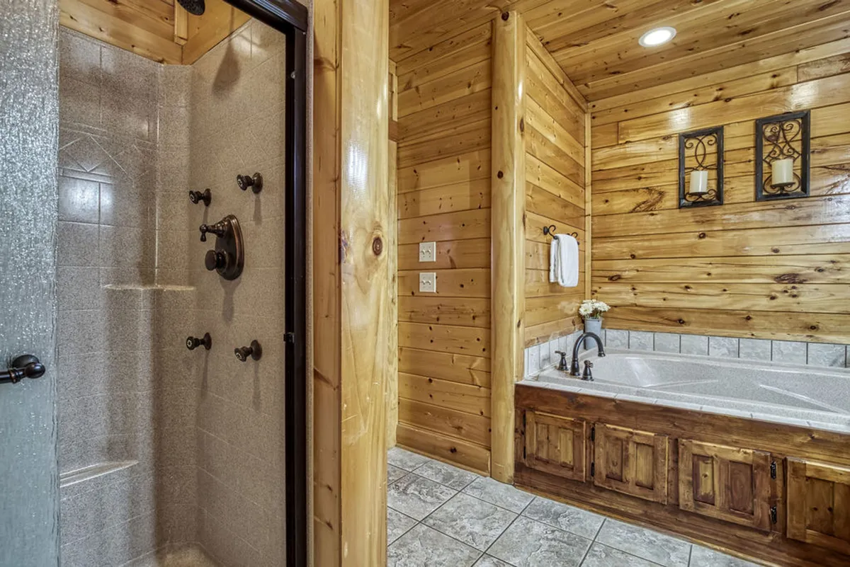 A spa-like bathroom with a soaking bathtub and a modern shower area, framed by wooden walls and tasteful decorative accents. The space radiates tranquility and encourages self-care and rejuvenation.